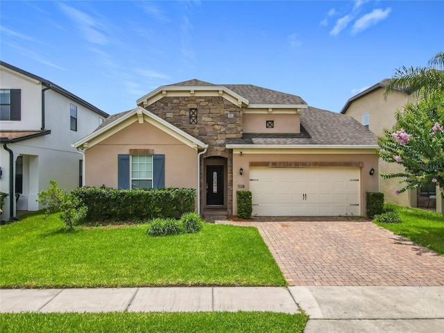 1138 Fountain Coin Loop, Orlando, FL 32828 - traditional home with stucco siding, decorative driveway, a front yard, an attached garage, and stone siding