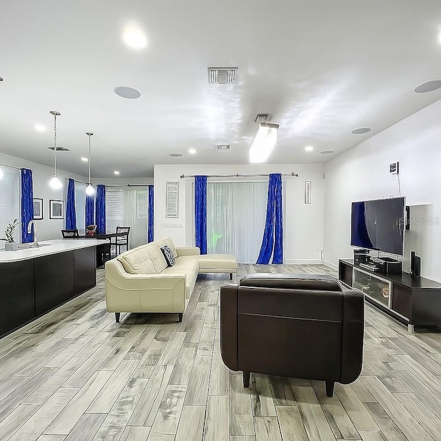 1138 Fountain Coin Loop, Orlando, FL 32828 - living room with wood tiled floors and recessed lighting