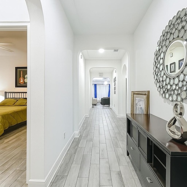 1138 Fountain Coin Loop, Orlando, FL 32828 - hall featuring arched walkways and wood tiled floors
