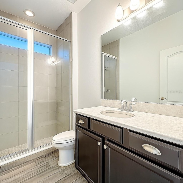 1138 Fountain Coin Loop, Orlando, FL 32828 - full bath with vanity, a shower stall, and wood finished floors