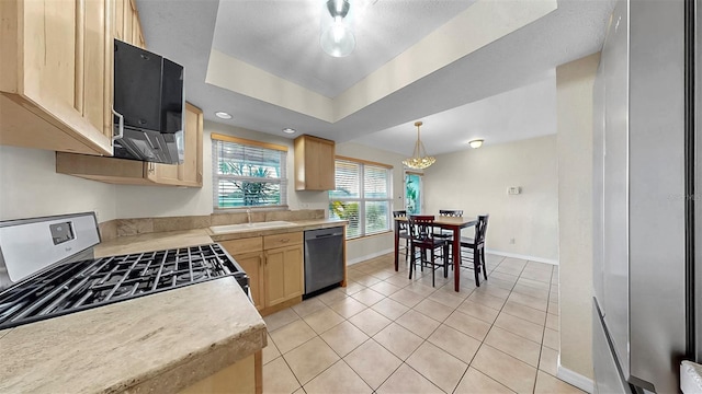 11460 Park Blvd, Seminole, FL 33772 - kitchen featuring appliances with stainless steel finishes, light countertops, light brown cabinetry, and light tile patterned floors