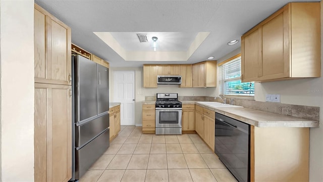 11460 Park Blvd, Seminole, FL 33772 - kitchen featuring stainless steel appliances, light brown cabinets, light countertops, light tile patterned floors, and recessed lighting