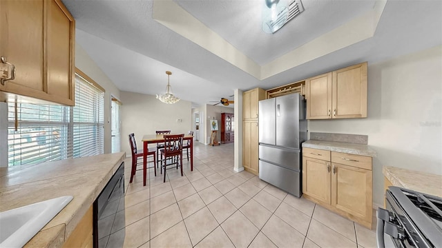 11460 Park Blvd, Seminole, FL 33772 - kitchen with stainless steel appliances, light brown cabinetry, light tile patterned flooring, light countertops, and a ceiling fan