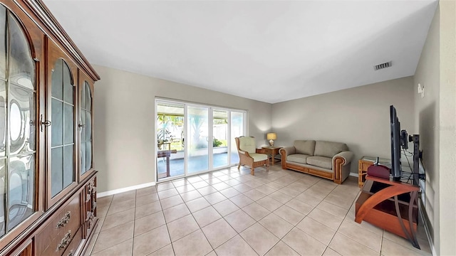 11460 Park Blvd, Seminole, FL 33772 - living room featuring light tile patterned floors and baseboards