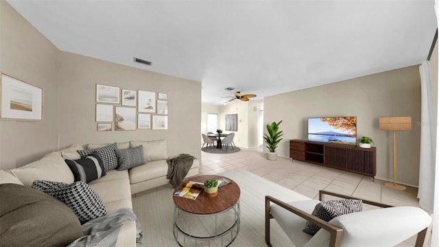 11460 Park Blvd, Seminole, FL 33772 - living room with light tile patterned floors and a ceiling fan