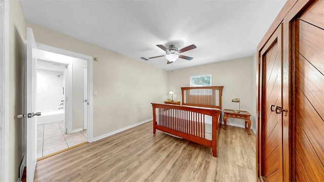 11460 Park Blvd, Seminole, FL 33772 - bedroom with light wood-style floors, a closet, and a ceiling fan