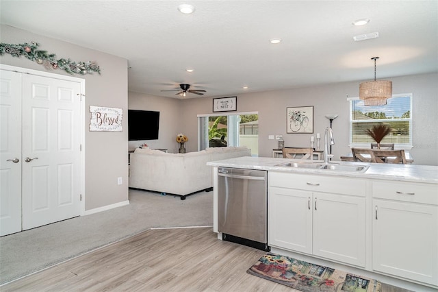 1518 Louise Ave, Auburndale, FL 33823 - kitchen featuring dishwasher, light wood-style floors, a ceiling fan, white cabinets, and pendant lighting