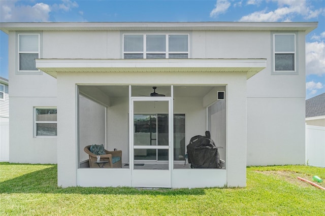1518 Louise Ave, Auburndale, FL 33823 - back of house with a sunroom, a yard, and stucco siding