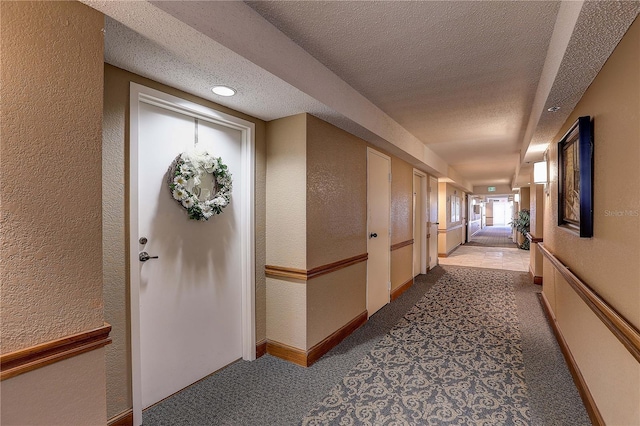 2333 Feather Sound Dr Unit A409, Clearwater, FL 33762 - corridor with a textured wall, carpet flooring, and a textured ceiling