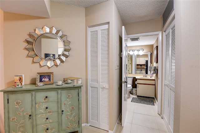 2333 Feather Sound Dr Unit A409, Clearwater, FL 33762 - corridor with light tile patterned floors and a textured ceiling