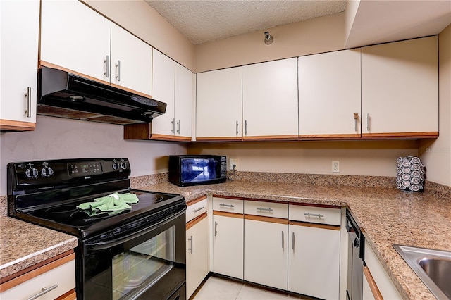 2333 Feather Sound Dr Unit A409, Clearwater, FL 33762 - kitchen with black appliances, range hood, white cabinets, light countertops, and a textured ceiling