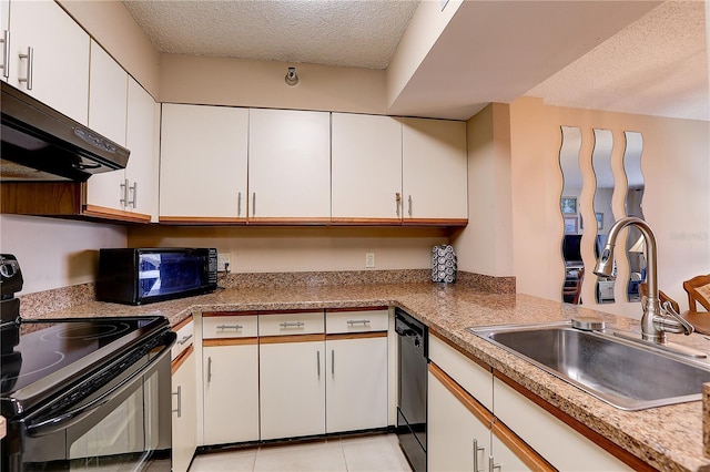 2333 Feather Sound Dr Unit A409, Clearwater, FL 33762 - kitchen with black appliances, a textured ceiling, ventilation hood, white cabinetry, and light tile patterned floors