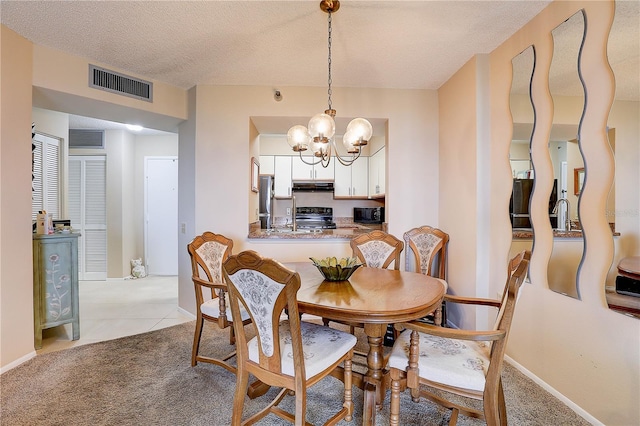 2333 Feather Sound Dr Unit A409, Clearwater, FL 33762 - carpeted dining room featuring a chandelier, a textured ceiling, and tile patterned flooring