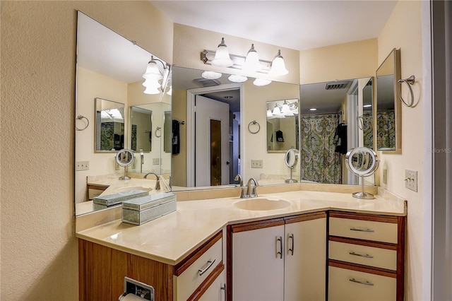 2333 Feather Sound Dr Unit A409, Clearwater, FL 33762 - bathroom featuring a chandelier, vanity, and a textured wall