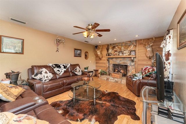 2410 Thornton Rd, Zolfo Springs, FL 33890 - living room featuring wood finished floors, ceiling fan, wooden walls, a stone fireplace, and recessed lighting