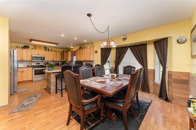2410 Thornton Rd, Zolfo Springs, FL 33890 - dining space with a chandelier, light wood finished floors, a wainscoted wall, and recessed lighting