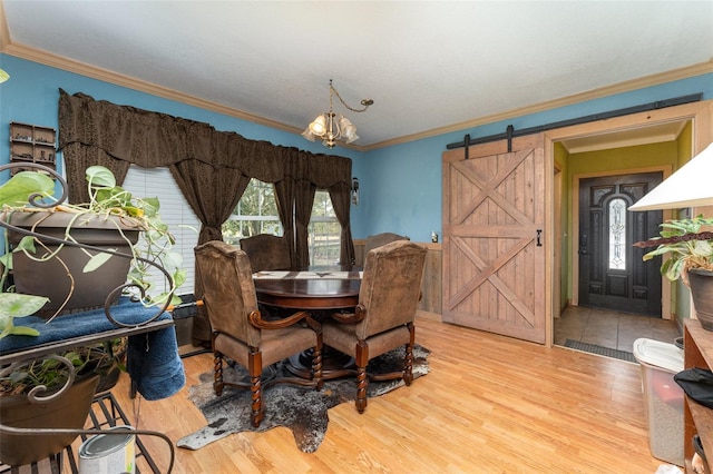2410 Thornton Rd, Zolfo Springs, FL 33890 - dining area with a barn door, ornamental molding, a chandelier, and wood finished floors
