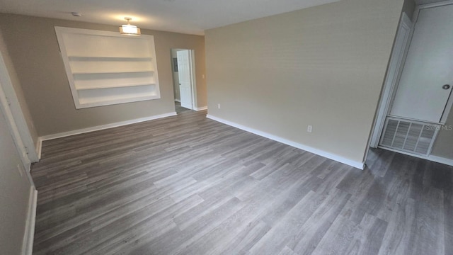 1514 Crest Ave, Leesburg, FL 34748 - unfurnished room featuring dark wood-style flooring and built in shelves
