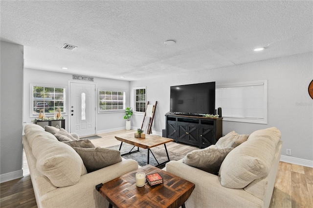 4460 67th St N, Saint Petersburg, FL 33709 - living room featuring light wood-style flooring, a textured ceiling, and recessed lighting