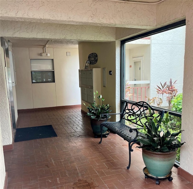 7893 Sailboat Key Blvd S Unit 304, South Pasadena, FL 33707 - hallway featuring brick patterned flooring and a textured wall