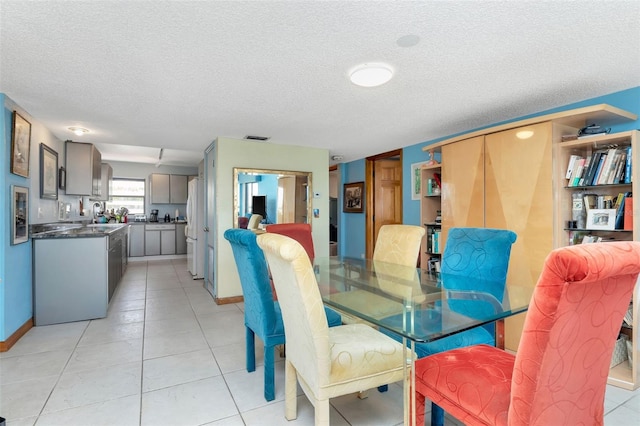 7893 Sailboat Key Blvd S Unit 304, South Pasadena, FL 33707 - dining room featuring a textured ceiling and light tile patterned floors