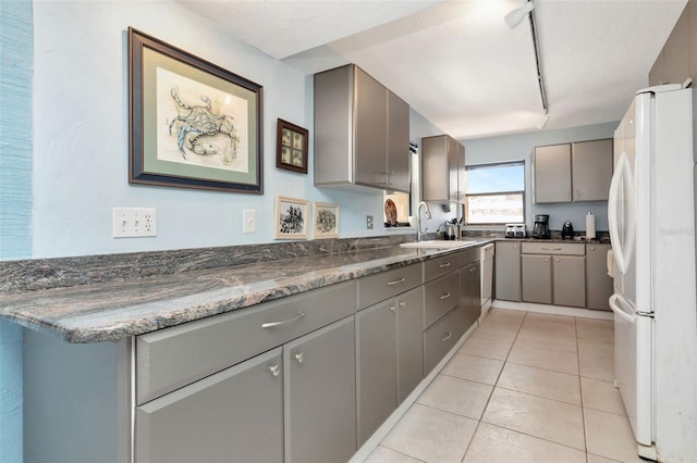 7893 Sailboat Key Blvd S Unit 304, South Pasadena, FL 33707 - kitchen with white appliances, gray cabinets, track lighting, and light tile patterned flooring