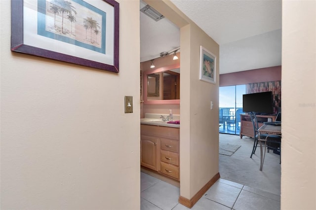 7893 Sailboat Key Blvd S Unit 304, South Pasadena, FL 33707 - corridor with light tile patterned floors, rail lighting, and light colored carpet