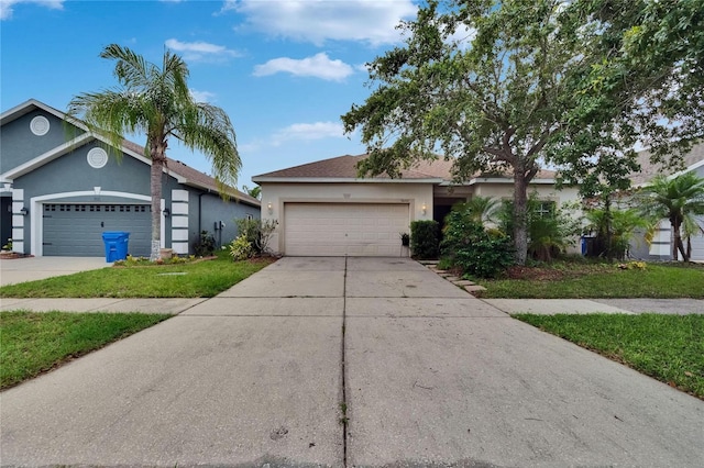7603 Wood Violet Dr, Gibsonton, FL 33534 - ranch-style house with a garage, stucco siding, and concrete driveway