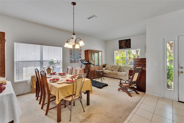 7603 Wood Violet Dr, Gibsonton, FL 33534 - dining room featuring a chandelier, light carpet, and light tile patterned floors