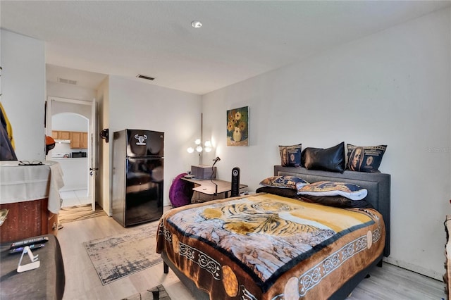 7603 Wood Violet Dr, Gibsonton, FL 33534 - bedroom with freestanding refrigerator and light wood-style floors