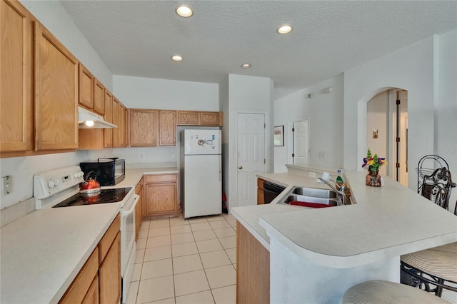 7603 Wood Violet Dr, Gibsonton, FL 33534 - kitchen featuring black appliances, under cabinet range hood, a kitchen bar, light tile patterned floors, and light countertops