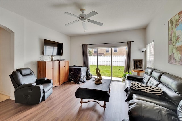 7603 Wood Violet Dr, Gibsonton, FL 33534 - living room with arched walkways, light wood finished floors, and ceiling fan