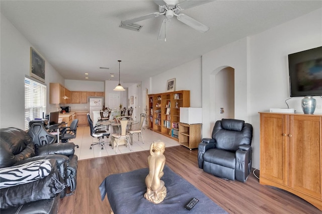 7603 Wood Violet Dr, Gibsonton, FL 33534 - living area featuring arched walkways, light wood-type flooring, and a ceiling fan