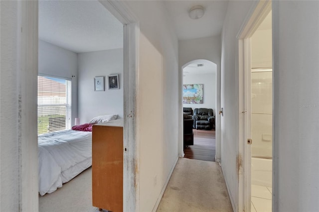 7603 Wood Violet Dr, Gibsonton, FL 33534 - corridor featuring arched walkways and light carpet