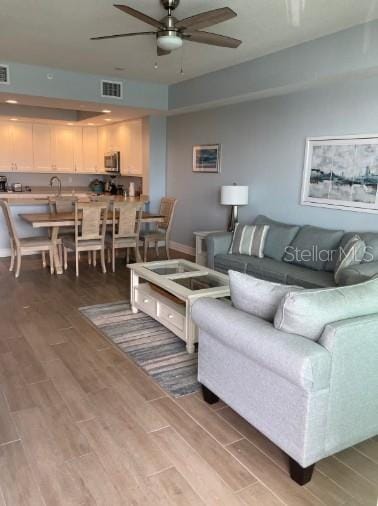 706 Bayway Blvd Unit 502, Clearwater Beach, FL 33767 - living room with ceiling fan and light wood-style floors