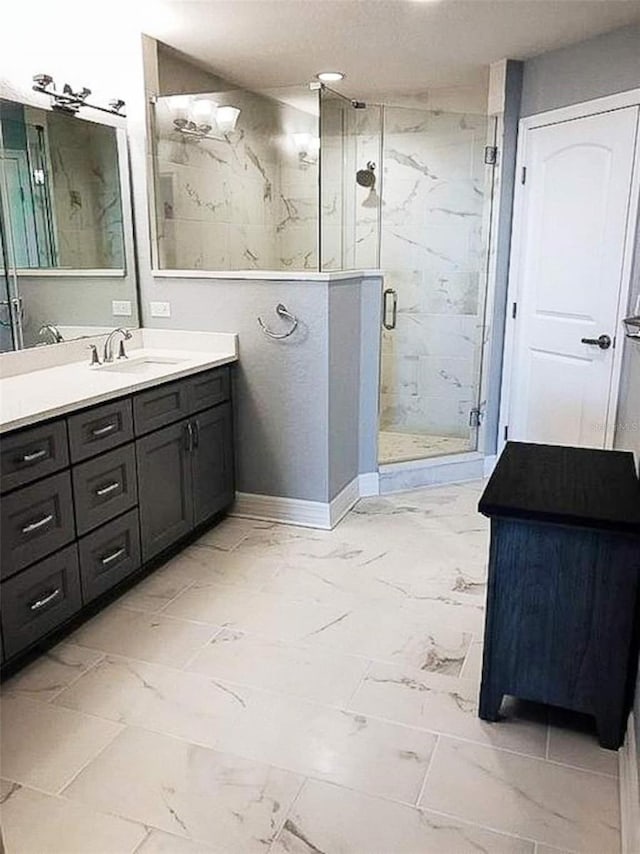 706 Bayway Blvd Unit 502, Clearwater Beach, FL 33767 - bathroom featuring marble finish flooring, vanity, and a marble finish shower