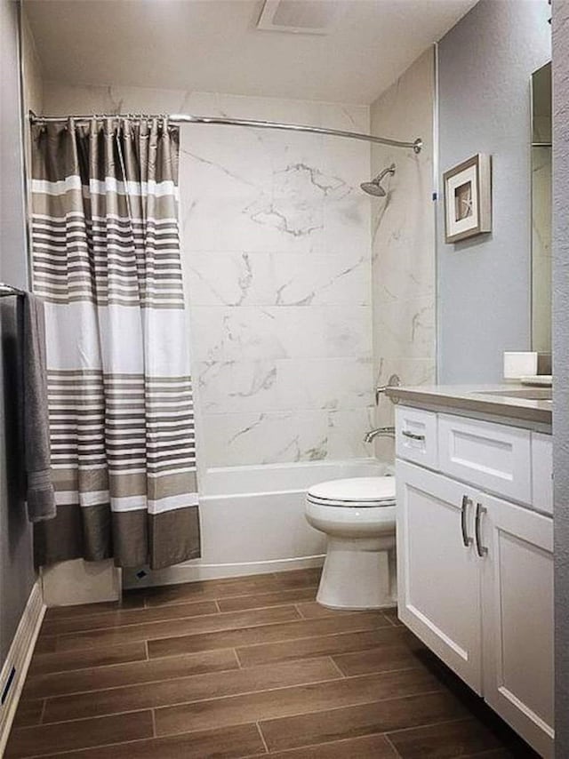 706 Bayway Blvd Unit 502, Clearwater Beach, FL 33767 - bathroom featuring wood finish floors, vanity, and shower / tub combo with curtain