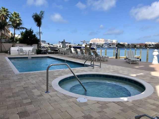 706 Bayway Blvd Unit 502, Clearwater Beach, FL 33767 - community pool with a patio area, a water view, and a community hot tub