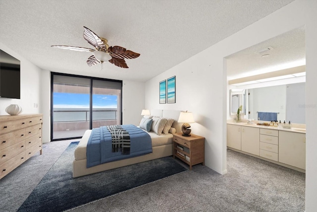1340 Gulf Blvd Unit 12A, Clearwater Beach, FL 33767 - bedroom with access to exterior, a textured ceiling, light carpet, a wall of windows, and a ceiling fan