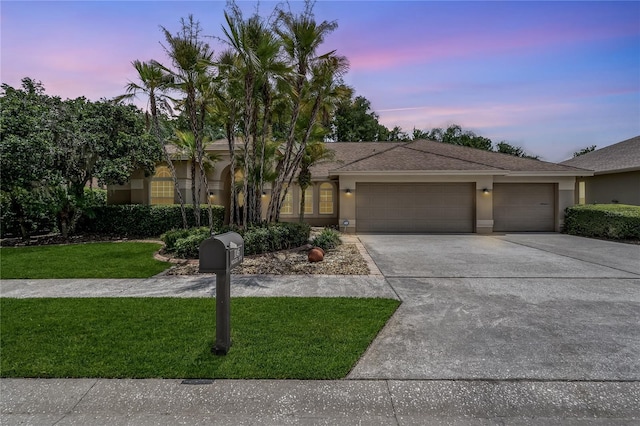 1046 Middlesex Dr, New Port Richey, FL 34655 - view of front of house featuring a garage, driveway, a lawn, and stucco siding