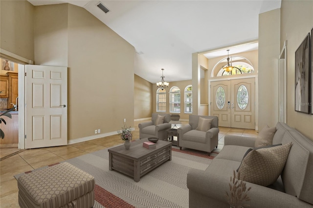 1046 Middlesex Dr, New Port Richey, FL 34655 - living area with high vaulted ceiling, tile patterned flooring, and a chandelier