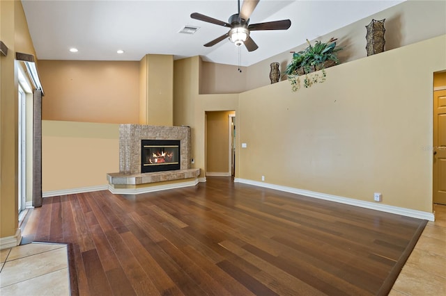 1046 Middlesex Dr, New Port Richey, FL 34655 - unfurnished living room featuring a ceiling fan, wood finished floors, a tile fireplace, and recessed lighting