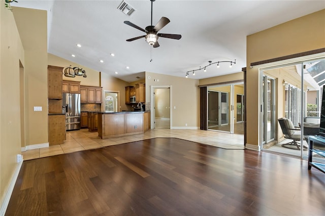 1046 Middlesex Dr, New Port Richey, FL 34655 - unfurnished living room featuring light wood-style floors, ceiling fan, vaulted ceiling, and recessed lighting