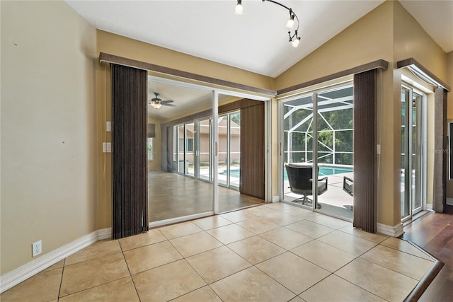 1046 Middlesex Dr, New Port Richey, FL 34655 - unfurnished room featuring a sunroom, vaulted ceiling, ceiling fan, and light tile patterned flooring
