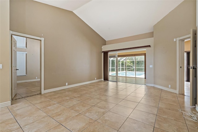 1046 Middlesex Dr, New Port Richey, FL 34655 - spare room featuring light tile patterned flooring and high vaulted ceiling