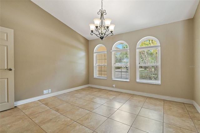 1046 Middlesex Dr, New Port Richey, FL 34655 - empty room with light tile patterned floors and a chandelier