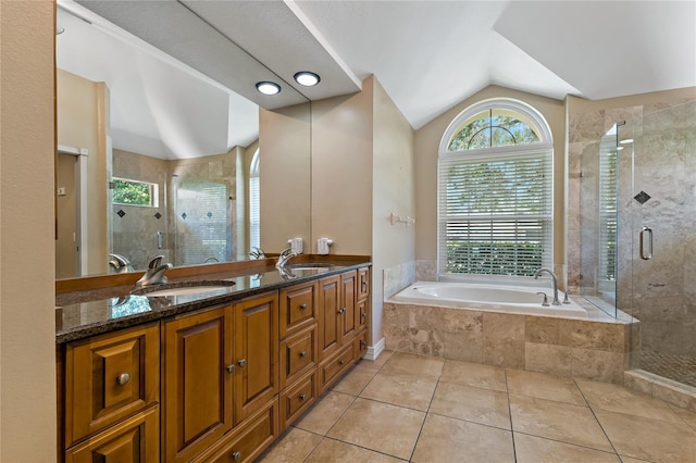 1046 Middlesex Dr, New Port Richey, FL 34655 - full bath featuring a garden tub, a stall shower, double vanity, tile patterned flooring, and vaulted ceiling
