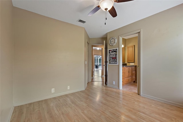 1046 Middlesex Dr, New Port Richey, FL 34655 - empty room with light wood finished floors and a ceiling fan