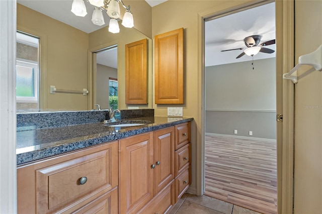 1046 Middlesex Dr, New Port Richey, FL 34655 - bathroom with plenty of natural light, vanity, a ceiling fan, and tile patterned flooring