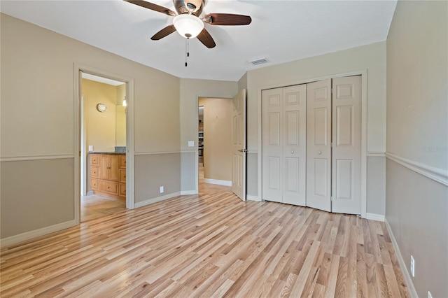 1046 Middlesex Dr, New Port Richey, FL 34655 - unfurnished bedroom featuring light wood-type flooring, a closet, connected bathroom, and a ceiling fan